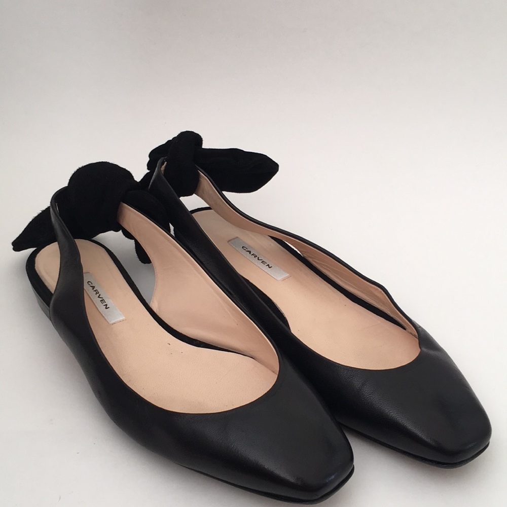 Black leather flats with bow in the back